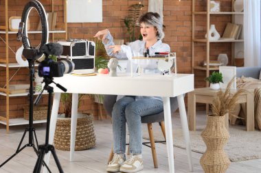 Makyaj çantası olan kadın güzellik blogcusu evinde video kaydediyor