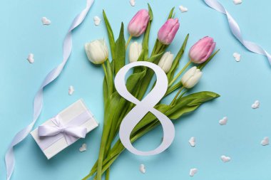 Lale çiçekleri ve mavi arka planda hediye kutusu olan kağıttan yapılmış 8 figür. Uluslararası Kadınlar Günü kutlamaları