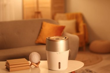 Akşam oturma odasındaki sehpada modern nemlendirici var.