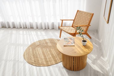 Işık perdesi, tahta koltuğu ve masası olan oturma odası.