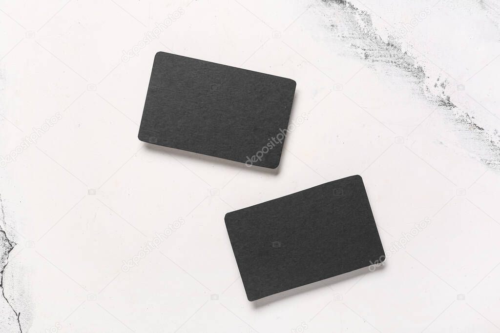 Blank black business cards on white marble background