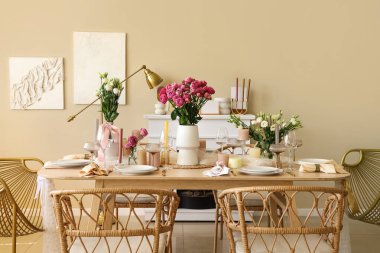 Beautiful table setting with flowers and candles for wedding celebration in room