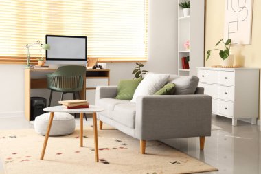 Çalışma odası, kanepe ve raf ünitesi olan bir oturma odası.