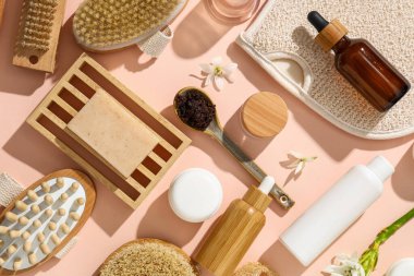 Antiselülit masajı ve bej arka planda çiçekler için kozmetik ürünler.