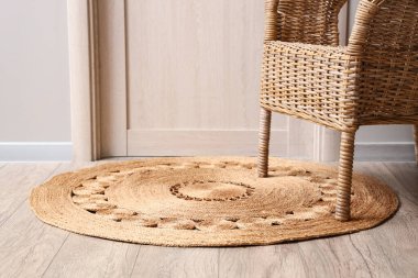 Odadaki halının üzerindeki hasır koltuk.