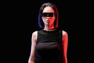 Siyah arka planda VR gözlüklü genç kadın.