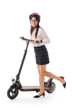 Beyaz arka planda elektrikli scooterı olan Asyalı genç bir iş kadını.