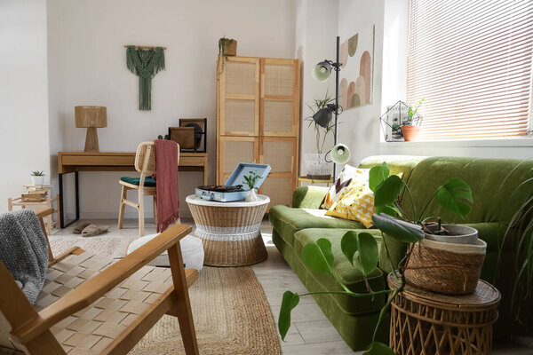 Interior of living room with record player, sofa and workplace