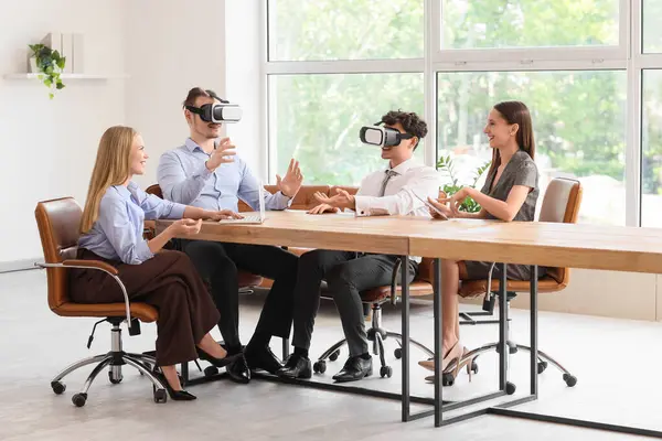 Genç iş arkadaşları ofiste VR gözlüklerini kullanıyorlar.