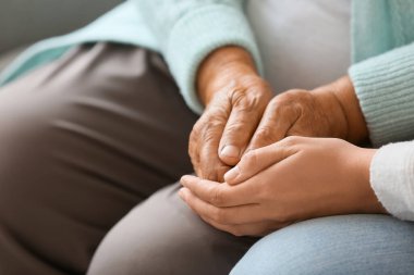 Evde el ele tutuşan, kızı olan son sınıf öğrencisi bir kadın.