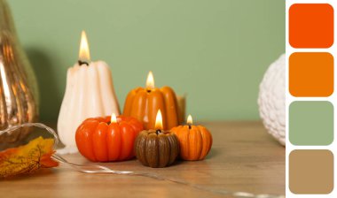 Balkabağı şeklinde mumlar ve sonbahar yaprakları evdeki yeşil duvarın yanında klozette yanıyor.