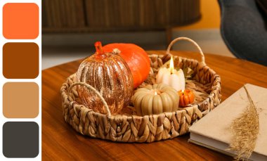 Balkabağı şeklinde mumlar yakan sepet ve evdeki sehpanın üzerinde kitap, yakın plan.