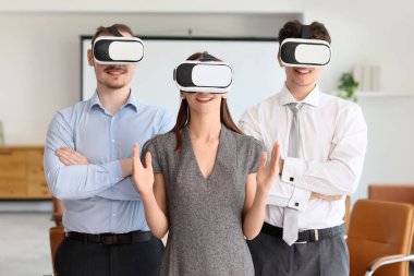 Genç iş adamları ofiste VR gözlüğü kullanıyorlar.