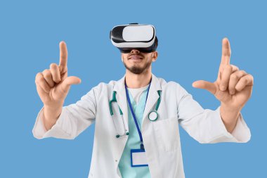 VR gözlüklü erkek doktor mavi arka planda bir şey gösteriyor.