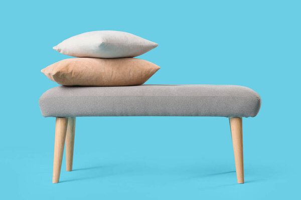 Soft bench with pillows on blue background