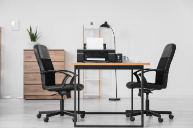 Masasında yazıcı olan modern ofisin içi