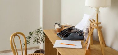 Vintage typewriter and lamp on table in author's office