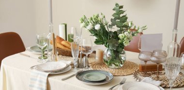 Beautiful table setting with eustoma flowers for wedding celebration in room