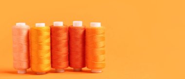 Turuncu arkaplanda metin için boşluk içeren iplik makaraları