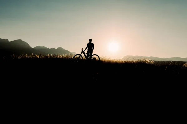 Bike adventure in the mountains. Mountain bike silhouette.