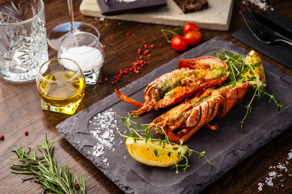 stock image Lobster with flavored butter. Herb butter, lemon. Delicious healthy traditional food closeup served for lunch in modern gourmet cuisine restaurant.