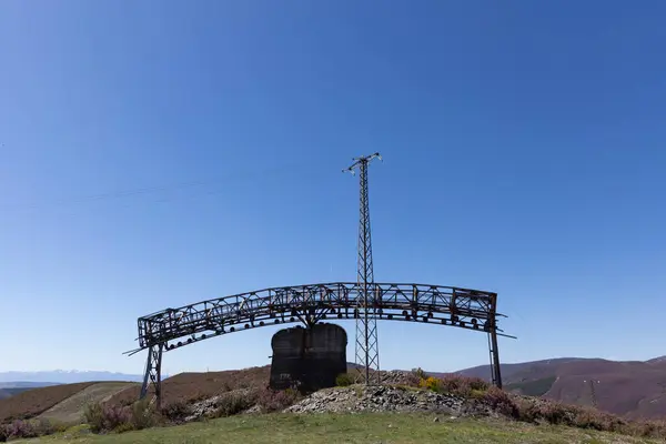 stock image Metal structure tower with concrete base from coal mine cable cart industrial abandoned cableway on a spring sunny day in Tormaleo province of Asturias Spain
