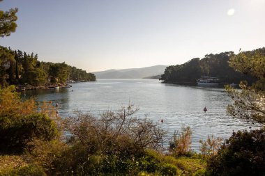 Kibar dalgaların çakıllı bir sahile vuruşunun resimsel bir sahnesi. 