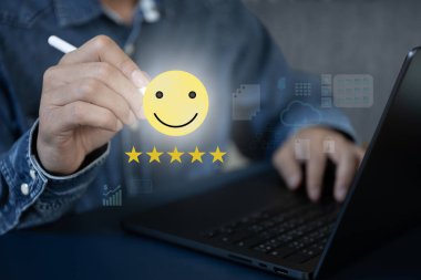 İşadamı dizüstü bilgisayarla çalışıyor. Müşteri memnuniyeti skoruna dokunmak için elektronik kalem kullanıyor. Ekranda süzülüyor.