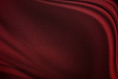 Zarif kıvrımlı, zarif, zarif parlak efektli, koyu kırmızı ipek kumaş.