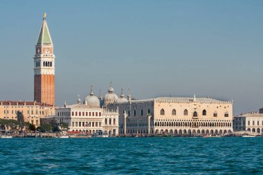 Doges palace, Library and St. Marco tower, coloumns of St. Marco and St. Theodor from water, gondolas around, Venice, Italy.