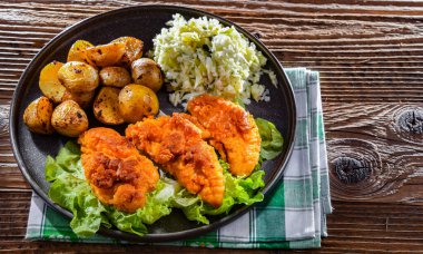 Patates ve lahana ile servis edilen kızarmış tavuk pirzolası..