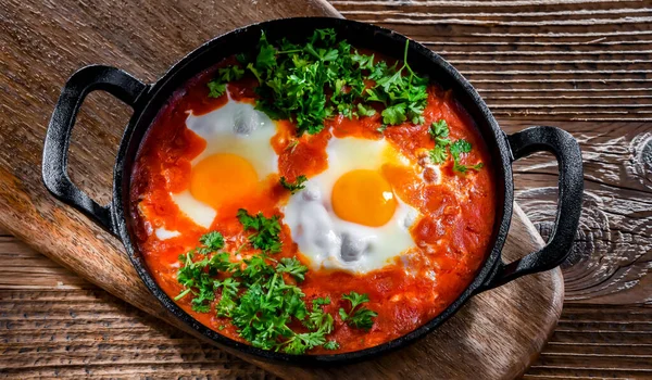 stock image Shakshouka dish in a cast iron pan.