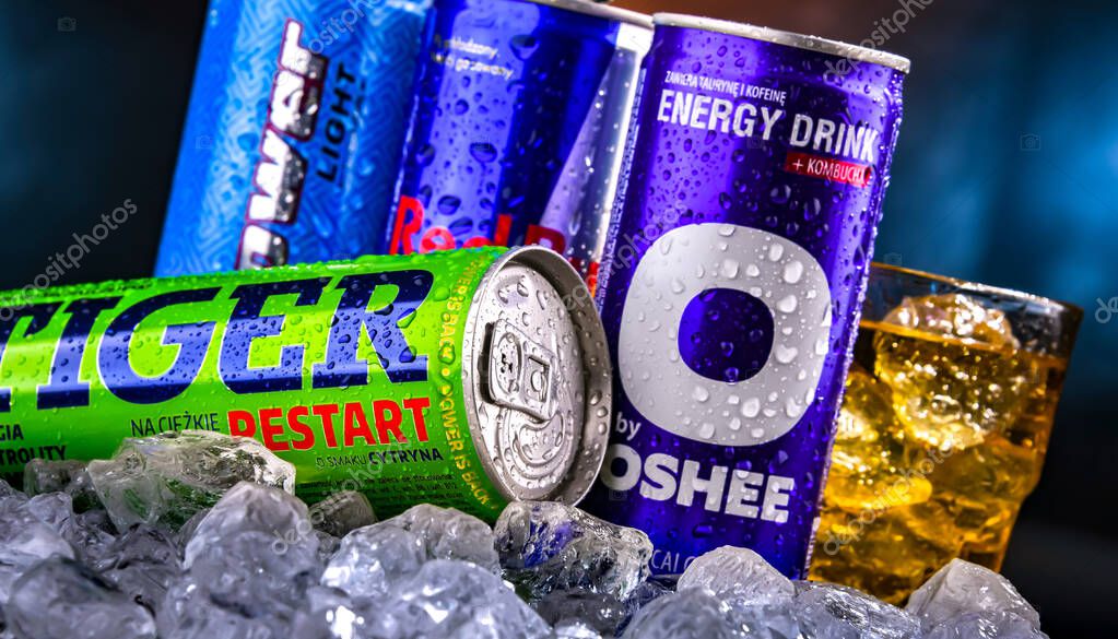 POZNAN, POL - NOV 25, 2022: Cans of popular global energy drinks, beverages containing stimulant drugs and marketed as providing mental and physical stimulation