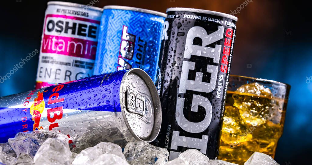 POZNAN, POL - NOV 25, 2022: Cans of popular global energy drinks, beverages containing stimulant drugs and marketed as providing mental and physical stimulation