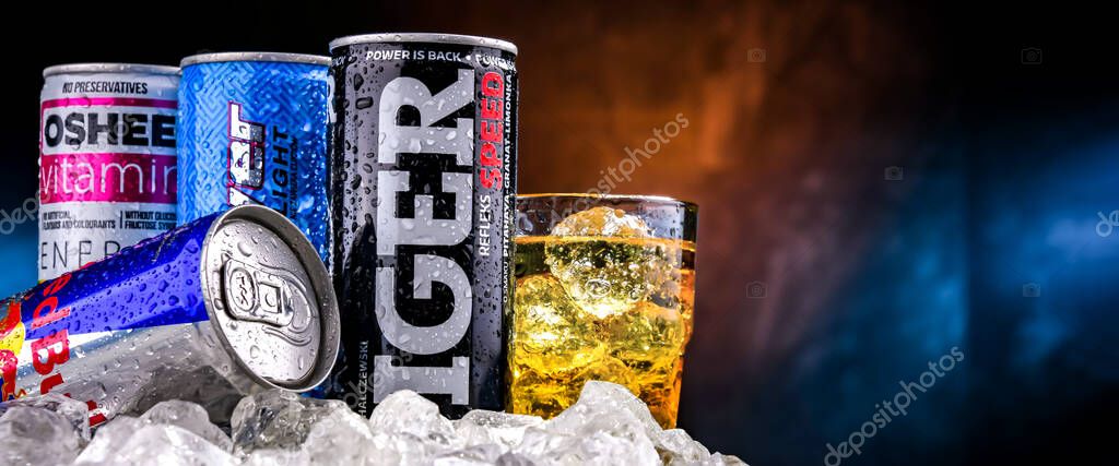 POZNAN, POL - NOV 25, 2022: Cans of popular global energy drinks, beverages containing stimulant drugs and marketed as providing mental and physical stimulation