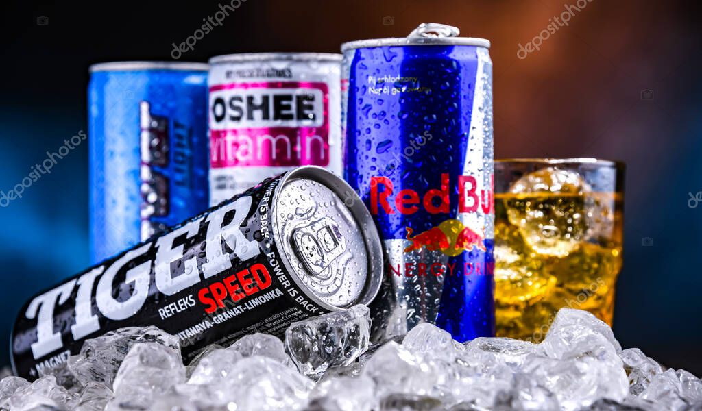 POZNAN, POL - NOV 25, 2022: Cans of popular global energy drinks, beverages containing stimulant drugs and marketed as providing mental and physical stimulation