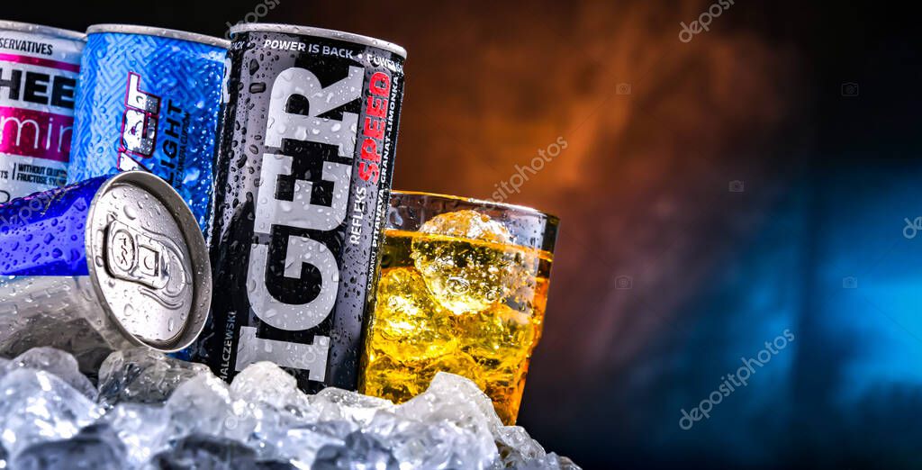 POZNAN, POL - NOV 25, 2022: Cans of popular global energy drinks, beverages containing stimulant drugs and marketed as providing mental and physical stimulation