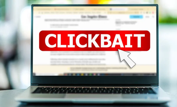 Laptop computer displaying the sign of clickbait on on the Internet