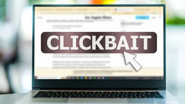 Laptop computer displaying the sign of clickbait on on the Internet