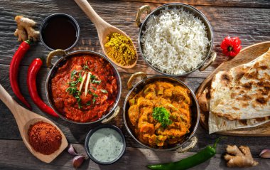 Hot madras paneer and vegetable masala with basmati rice served in original indian karahi pots.