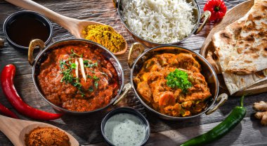 Hot madras paneer and vegetable masala with basmati rice served in original indian karahi pots.
