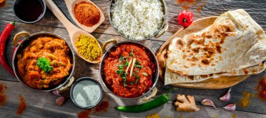 Hot madras paneer and vegetable masala with basmati rice served in original indian karahi pots.