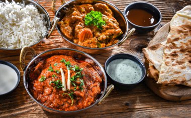 Hot madras paneer and vegetable masala with basmati rice served in original indian karahi pots.