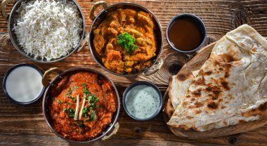Hot madras paneer and vegetable masala with basmati rice served in original indian karahi pots.