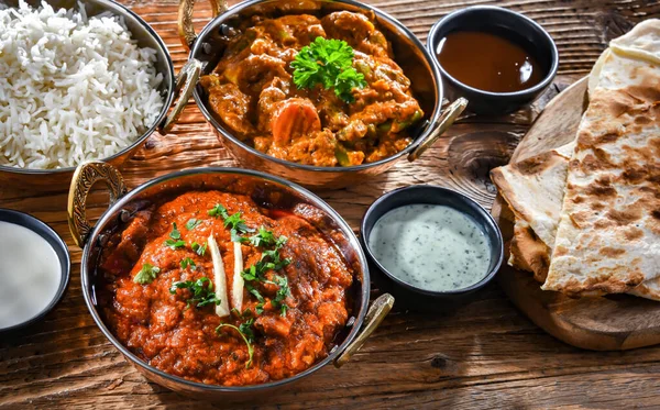 Hot madras paneer and vegetable masala with basmati rice served in original indian karahi pots.