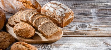 Assorted bakery products including loaves of bread and rolls