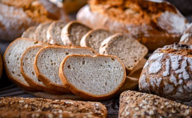Assorted bakery products including loaves of bread and rolls
