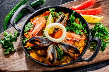 Seafood paella served in a cast iron pan.