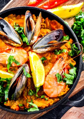 Seafood paella served in a cast iron pan.