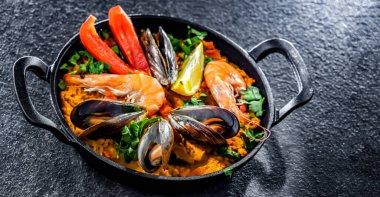 Seafood paella served in a cast iron pan.